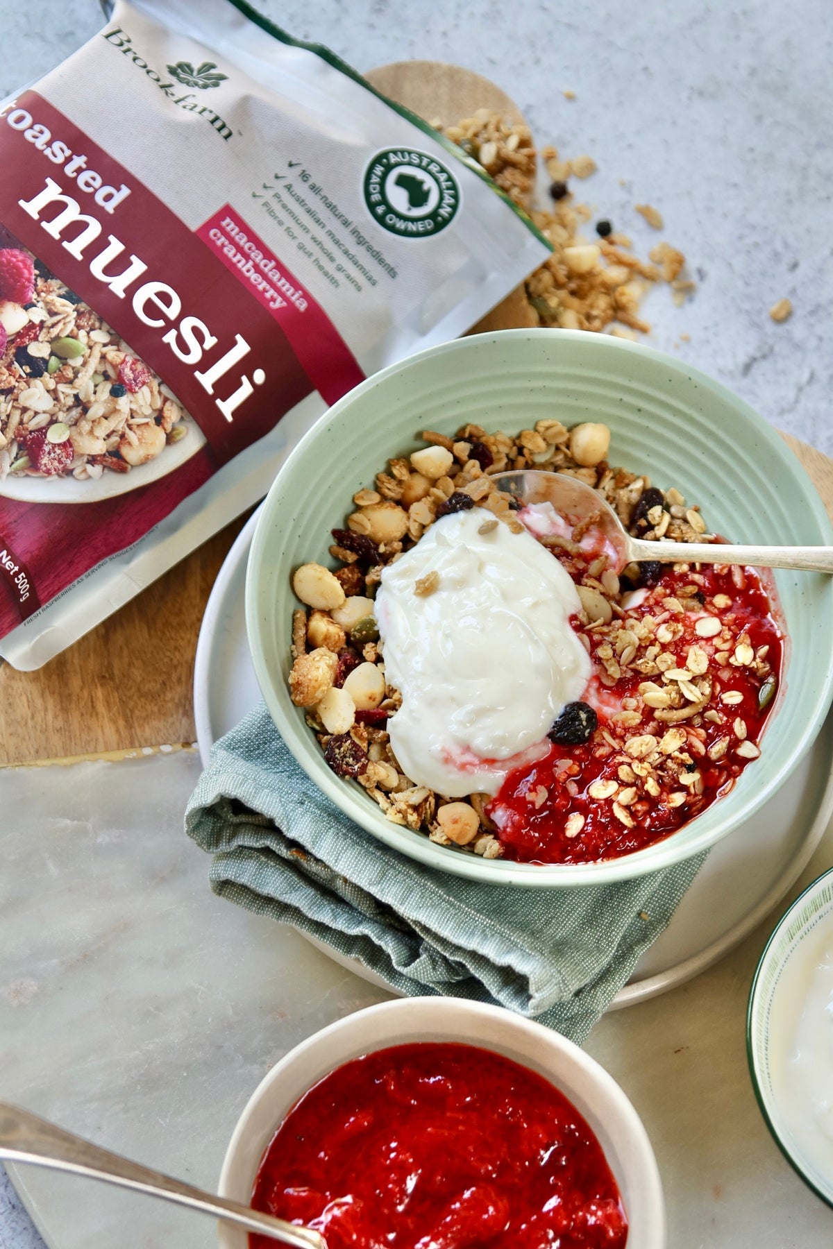 Breakfast bowl with Brookfarm roasted muesli, coconut yoghurt, and strawberry compote.