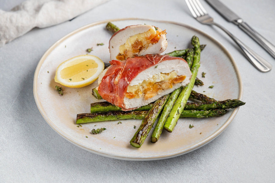 Camembert, macadamia and apricot stuffed chicken wrapped in prosciutto with roasted asparagus