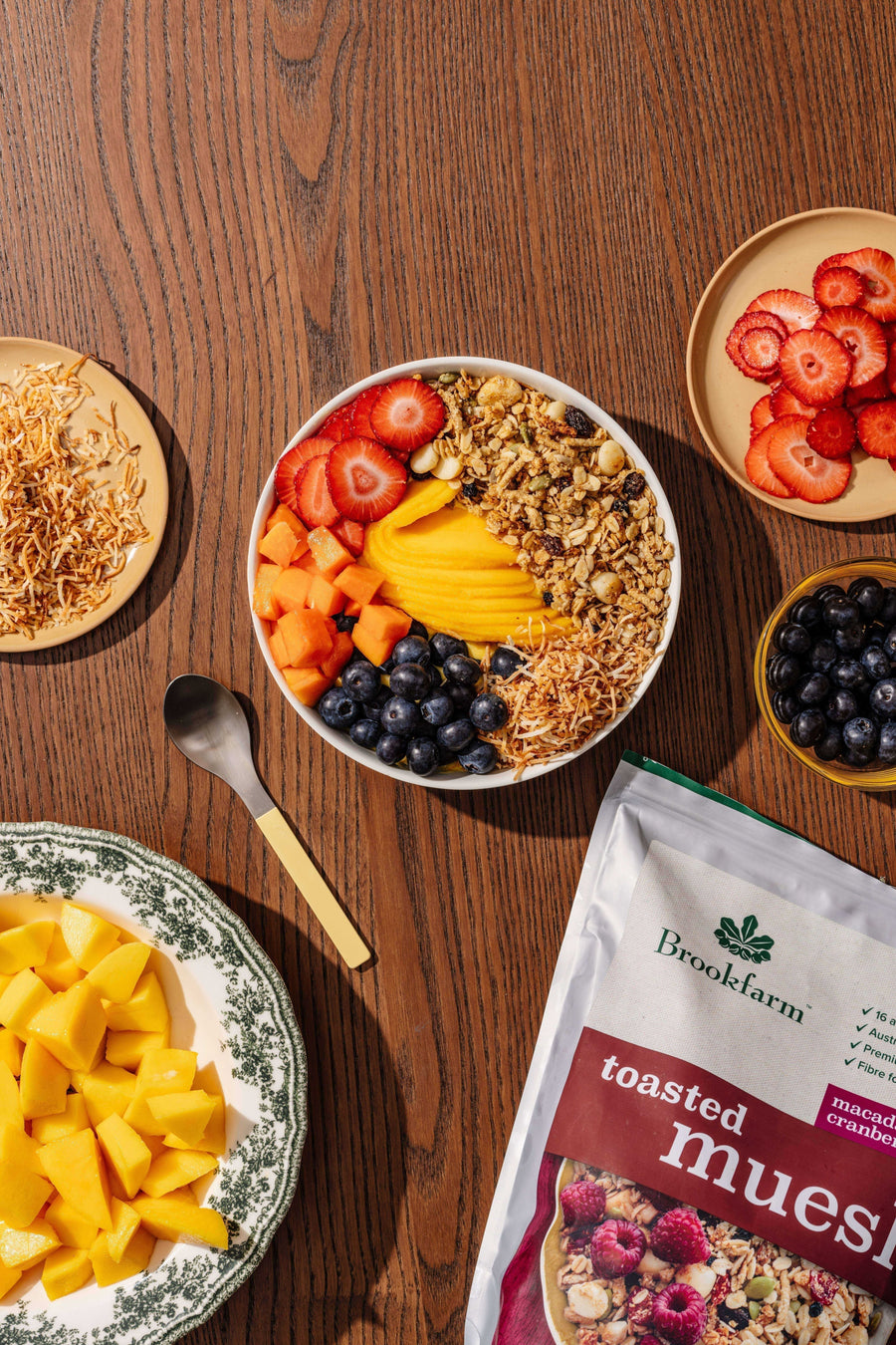 Brookfarm toasted muesli smoothie bowl with mango, strawberries, blueberries, and coconut