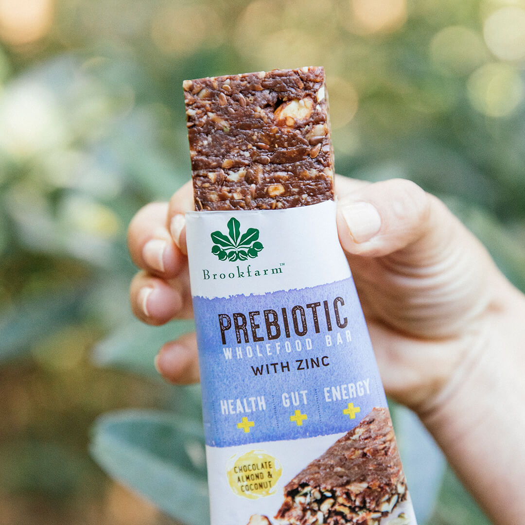 Lady holding Prebiotic Wholefood Bar Chocolate Almond & Coconut